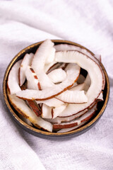 Dried coconut slices. Sliced dry coconut on a white background. Sun-dried fruit. close up