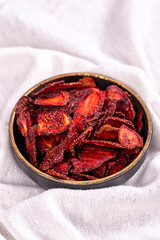 Dried strawberry slices. Sliced dried strawberries on a white background. Sun-dried fruit. close up