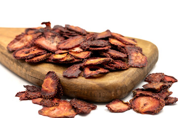 Dried strawberry slices. Sliced dried strawberries isolated on a white background. Sun-dried fruit. close up