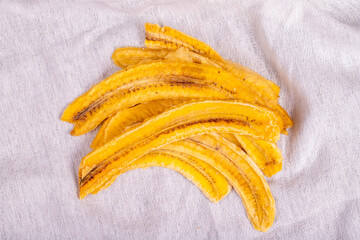 Dried banana slices. Sliced dried banana on white background. Sun-dried fruit. close up