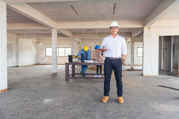 Fototapeta premium Construction engineer teamwork Safety Suit Trust Team Holding White Yellow Safety hard hat Security Equipment on Construction Site. Hardhat Protect Head for Civil Construction Engineer Concept
