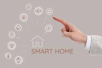 Man using digital screen with Smart Home interface on beige background, closeup