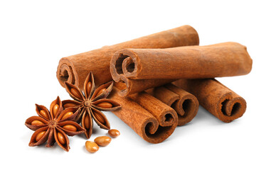 Aromatic cinnamon sticks and anise stars with seeds on white background
