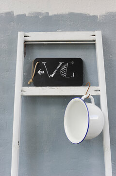 Chamber Pot Hanging On Ladder Holding Chalkboard Restroom Sign