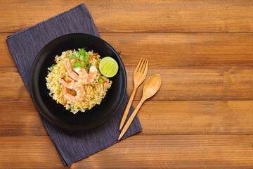 Thai Food - Fried rice with shrimp on wood background.from top view