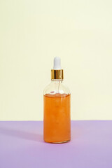 Front view of orange face serum bottle.