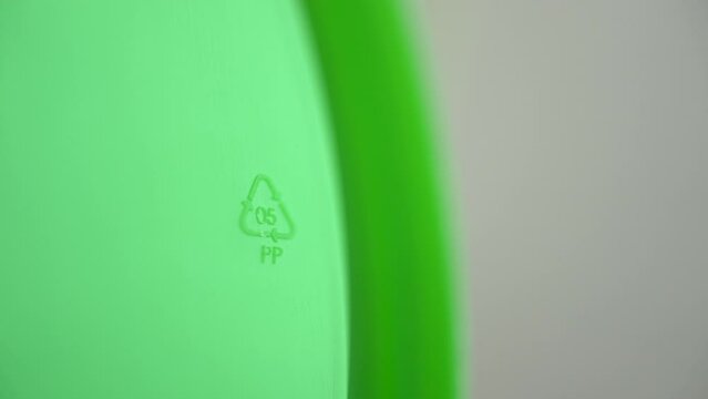 4k Closeup view of 05 pp recycling sign on green product packaging spbd. Polypropylene: bottle caps, pails and buckets, yogurt cups, lens packaging, rustling plastic packagies. It can be recycled