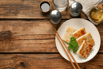 Delicious turnip cake with parsley served on wooden table, flat lay. Space for text