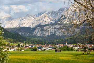 Fototapeta na wymiar Beautilful green meadow and alpine village in spring, Austria