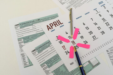 tax forms and next to the calendar with a date mark when you need to file a return.