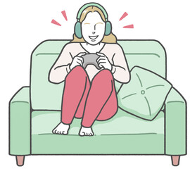 A young Western woman sitting on a sofa wearing headphones, enjoying a video game alone