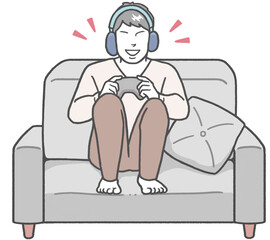 Young Asian man sitting on a sofa wearing headphones, enjoying a video game alone