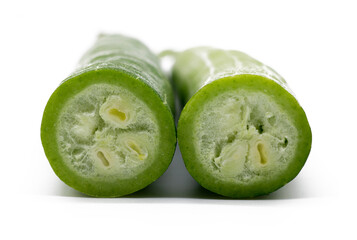 Snake gourd slices over white background.