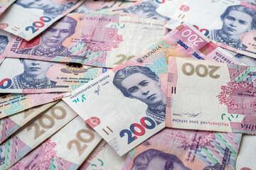 in the photo a lot of Ukrainian hryvnias scattered on the surface.