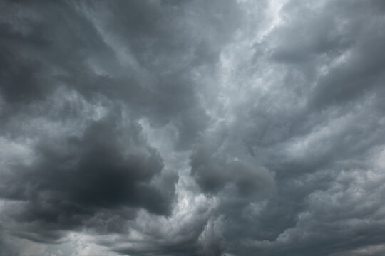 A dramatic dark storm cloudy sky or cloudscape.  Wide-angle view, gray clouds, no people