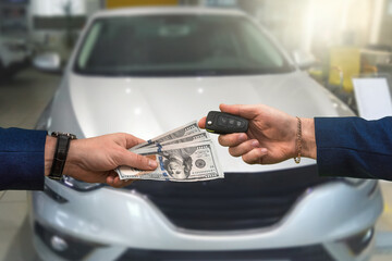 seller of a luxury car dealership gives owner the car keys and the other pays for the dollars.
