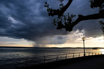 Heavy dark fast moving thunderstorm clouds over lake Constance, Germany