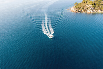 Motorboat, speed boat navigate on ocean, white wake. Summer vacation, Aegean Sea Greece. Aerial view