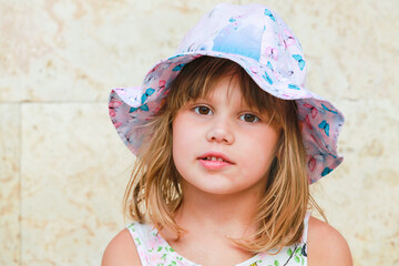 Cute European baby girl in colorful Panama hat