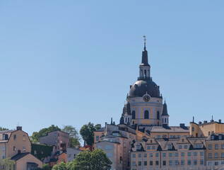 The church Katarina and old 1700s apartment buildings on the ride goof the district Södermalm a sunny summer day in Stockholm