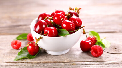 cherry fruit in bowl and leaf