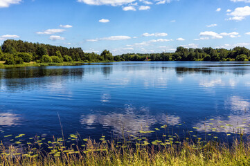 Summer view of a blue lake with a sky background