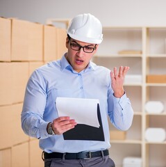 Young worker in the postal office dealing with parcels