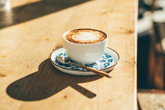 Cup of Coffee on wooden background.