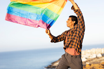 Happy man with a pride flag. LGBT community