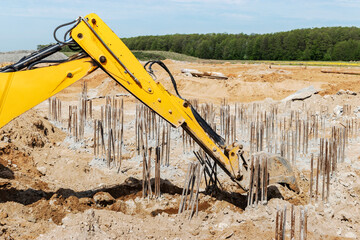 Excavator digs piles. Earthworks for the construction of the foundation. Construction equipment for...