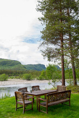 Wooden picnic area by the river in Honningsvag