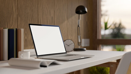 Home workspace with laptop mockup and accessories on table over wooden wall
