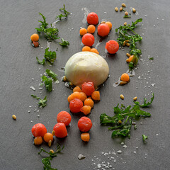 burrata cheese with melon salad and ruccola on crispy roasted pine nuts