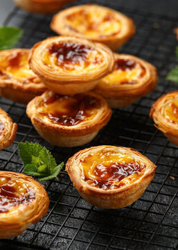 Traditional Portuguese custard tarts or Pastel de Nata freshly baked and cooling on rack