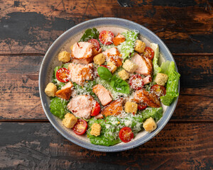 Salmon Caesar salad with grilled fish, croutons and cherry tomatoes