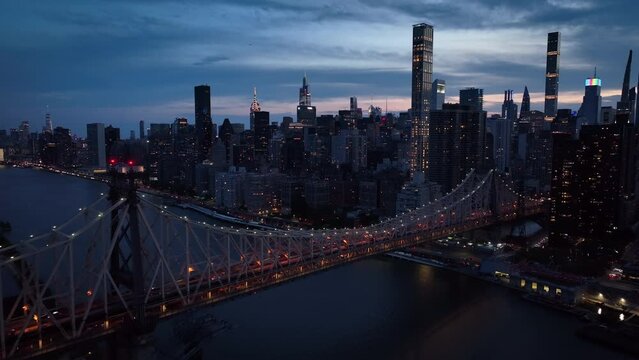 dusk flying over Ed Koch Queensboro Bridge towards NYC skyline