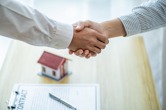 Businessman shaking hands successful making a deal. mans handshake. Business partnership Real estate meeting home purchase agreement concept.