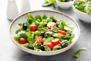 Salad with corn salad, cucumber, olives and tomato