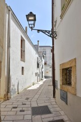A narrow street among the old houses of Irsina in Basilicata, region of southern Italy.