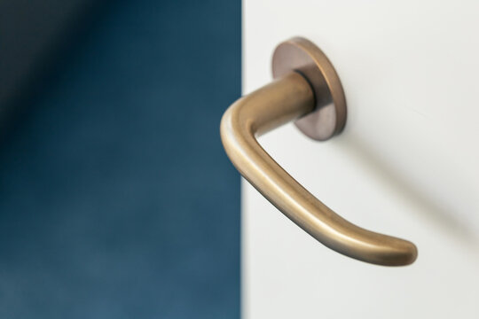 door knob or handle, antique brass lever handle for internal door, modern interior design concept, shallow depth of field