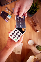 Overhead Shot Of Contactless Card Payment Being Taken From Bank Card For Handmade Candles