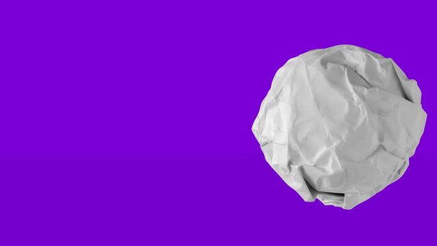 crumple the white paper into a ball rolling to the right and left stop motion.
