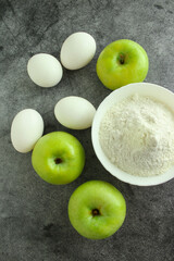 Pie ingredients, flour, green apples and eggs
