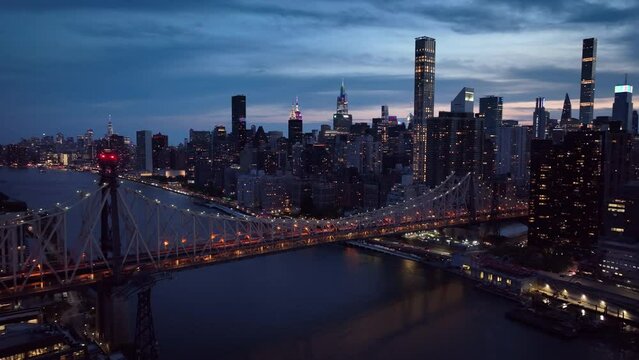 dusk flying counter clockwise view of Ed Koch Queensboro Bridge and NYC skyline