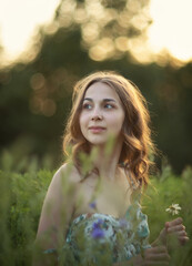 Photo of a beautiful girl in a summer meadow.