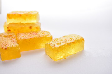 Pieces of marmalade in the foreground. Handmade marmalade with citruses on a white background, isolated. 