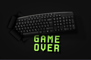 PC keyboard with words Game Over on black background