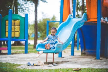 The girls enjoy playing slides in the playground.