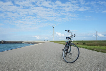 Fototapeta premium Windturbines view in Holland with elegant green bike at front