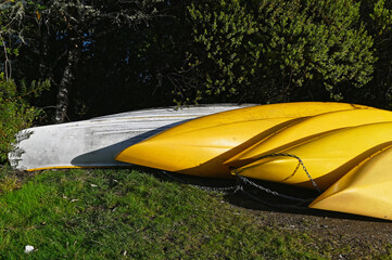 Kayaks lie upside down on the shore so as not to bill up with water
